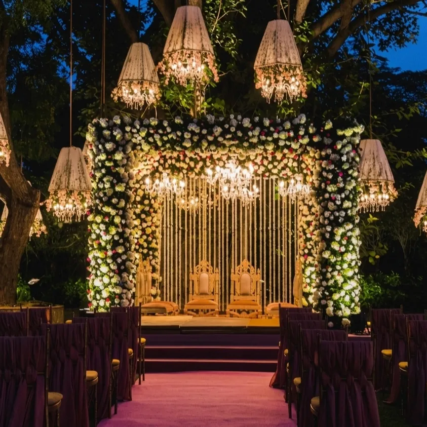Royal engagement stage decoration with floral mandap and chandelier lighting designed by Lotus Grandeure for a luxury wedding event in India